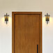 A wooden door with a Globe matte black LED wall sconce on it.