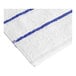 A Garnier-Thiebaut white pool towel with blue stripes.