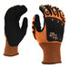 A close up of a small Cordova OGRE-Flex work glove with black and orange fabric.