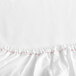 A close-up of a white Garnier-Thiebaut Georgetown fitted sheet with red thread.