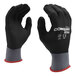 A pair of gray Cordova Conquest Ultra gloves with black foam nitrile and polyurethane palms.