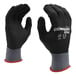 A close-up of a pair of black Cordova Conquest gloves with a black foam nitrile palm coating.