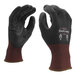 A pair of Cordova black cut-resistant gloves with a black polyurethane palm coating and a red stripe.