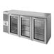 A True stainless steel back bar refrigerator with three glass doors.