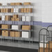 A warehouse with Lavex Pro wire shelves holding white boxes.