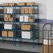 Blue Lavex Pro wire shelving in a warehouse with boxes on the shelves.