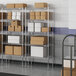 A metal Lavex Pro wire shelving unit with white boxes on the shelves.