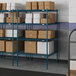 Blue Lavex Pro wire shelving in a warehouse with white boxes on the shelves.