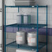 A Lavex Pro blue wire shelf with containers on top.