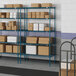 Blue metal Lavex Pro wire shelving with boxes on it.