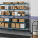 Blue metal Lavex Pro wire shelving with boxes on the shelves.