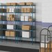 Lavex Pro blue metal wire shelving with boxes on the shelves.