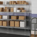 A metal wire shelving unit with white boxes on the shelves.