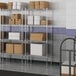 A metal wire shelf with boxes on it.