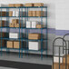 Lavex Pro blue metal wire shelving with boxes on the shelves.