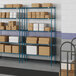 A Lavex Pro wire shelf with boxes on it.