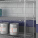 A Lavex Pro metal NSF wire shelf with containers on it.
