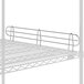 A metal shelf with a metal bar attachment.