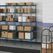 A blue metal Lavex Pro wire shelving unit with white boxes on the shelves.