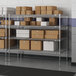 A metal Lavex Pro wire shelving unit with boxes on the shelves.