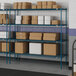 Blue Lavex Pro wire shelving unit with boxes on the shelves.