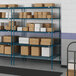 Blue metal Lavex Pro wire shelving with boxes on the shelves.