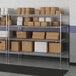 A metal Lavex Pro wire shelving unit with boxes on the shelves.