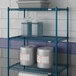 A Lavex Pro blue metal wire shelf with containers on it.