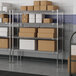 A metal Lavex Pro wire shelving unit with boxes on the shelves.