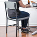 A woman sitting in a BFM Seating Memphis side chair at a table in a brewery tasting room.