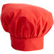 A red chef hat with ruffled edges.