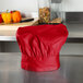 A red Intedge chef hat on a counter.