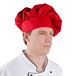 A man wearing a red Intedge chef hat.