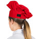 A woman wearing a red Intedge chef hat.