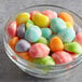 A bowl filled with colorful Albanese Eggstravagant gummy eggs.