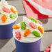 Two cups of sherbet ice cream with colorful candy on top.