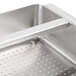 A stainless steel pre-rinse basket with a handle and holes.