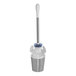 An OXO stainless steel toilet brush in a white container with a lid.