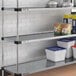 A Regency galvanized steel shelf holding containers and cans.