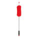 A long-handled dusting tool with a red microfiber head and a black grip handle.
