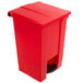 A red Rubbermaid step-on trash can with a lid.