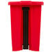 A red rectangular Rubbermaid step-on trash can with black handles.