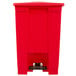 A red Rubbermaid step-on trash can with a lid.