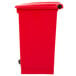 A Rubbermaid red rectangular step-on trash can with a lid.