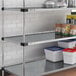 A Regency galvanized steel shelf with food and containers on it.