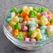 A glass bowl of Albanese Cottontail gummy candy on a table.