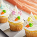 A group of cupcakes with frosting and bunny decorations.