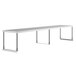 A long white rectangular table with a stainless steel Avantco single deck overshelf on metal legs.