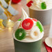 A cup of ice cream with Albanese Christmas Gummi Wreaths on top.