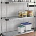 A Regency galvanized steel shelf with canned food and containers.